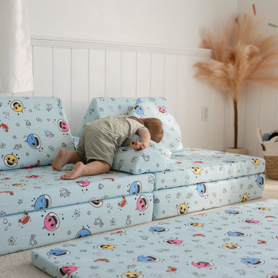 Toddler using Baby Shark™ x Roo & You™ Stepping Stones as a pillow while pretending to sleep.